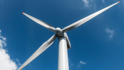 A modern wind turbine's powerful blades capture renewable energy against a clear blue sky, symbolizing the advancement of sustainable clean power technology for a greener future