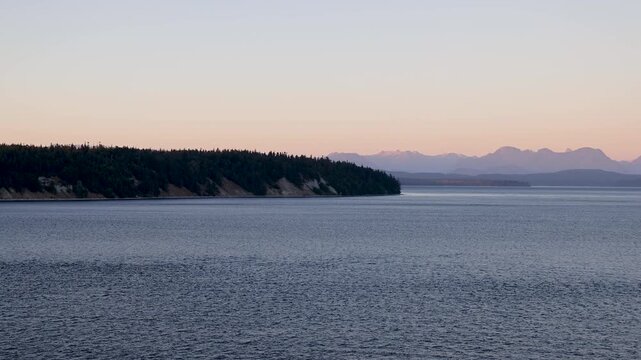 Quadra Island and Coast Mountains of British Columbia as seen from a Cruise Ship near sunset or dusk in summer