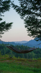 Wooden hanged Hammock between trees with mountain view