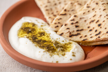 a p0late with labneh, pita bread and olive oil with zaatar  spices