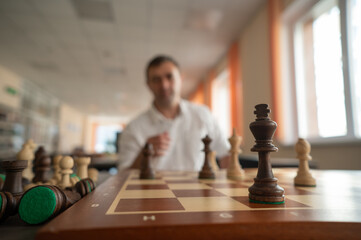 Middle aged Caucasian man playing chess. 