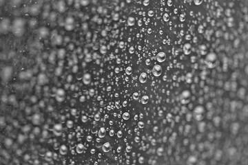 Rain drops on the glass dark moody texture background