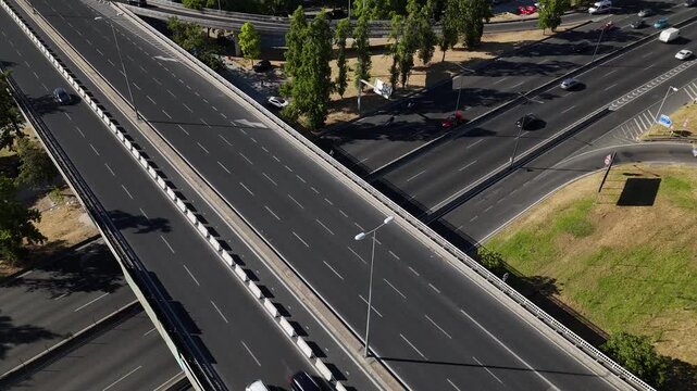 Busy highway intersection with smooth traffic flows in urban environment during daylight hours in Lisbon, Portugal