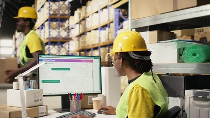 African american female verifying the shipment details on awb labels, using package tracking software system with accurate order status. Monitoring import export operations in depot. Camera A.