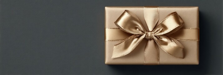 Elegant gold gift box on dark gray background