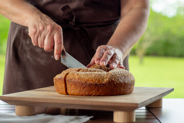 A gubana cake from Friuli, with a filling of dried fruit and nuts. The image shows the whole cake, ready to be sliced.