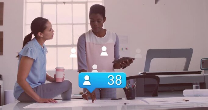 Bubble starting user icons rising while team reviewing design plans on tablet tracking engagement
