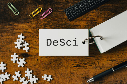 There is word card with the word DeSci. It is as an eye-catching image.