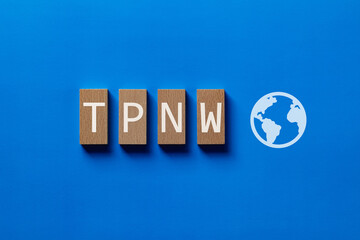 There is wood block with the word TPNW. It is an abbreviation for Treaty on the Prohibition of...