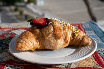 Italian breakfast, fresh baked butter croissant filled with ricotta cheese and jam, served outdoor...