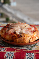 Fresh baked bread, pizza, focaccia or pala romana pizza with tomatoes, vegetables and cheese, street food in Palermo, Sicily, Italy, view on Mondello beach