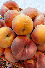 Fresh ripe sweet yellow and flat peaches Prunus persica or doughnut peach or Saturn peach