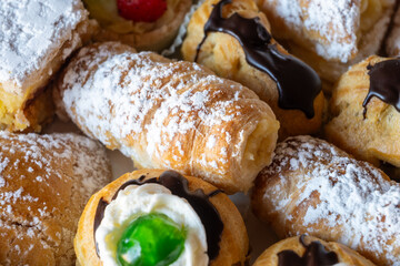 Italian sweet dessert dolce pastry and cakes with cream and fruits on plate made in artisanal...