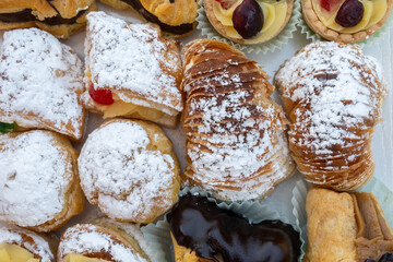 Italian sweet dessert dolce pastry and cakes with cream and fruits on plate made in artisanal...