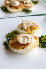 French high cuisine starter dish, pan fried chicken eggs with special filling and yellow sauce, vegetarian food in French restaurant