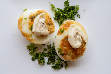 French high cuisine starter dish, pan fried chicken eggs with special filling and yellow sauce, vegetarian food in French restaurant