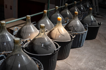 Dame Jeanne or demijohn glass jars for aging of natural sweet red grand cru wine Banyuls fortified...