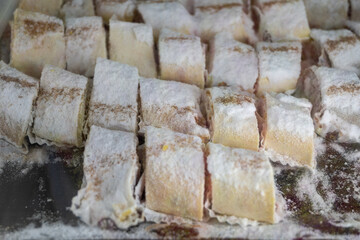 Sicilian desserts, sweets, cakes with ricotta cream, fruits, pistachio, on display in confectionery artisan shop