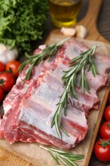 Fresh raw beef ribs and ingredients on table, closeup