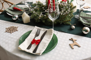 Festive table setting with Christmas wreath, closeup