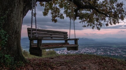 A serene swing hanging from a tree, offering a picturesque view of the landscape. A perfect spot for peace and reflection.