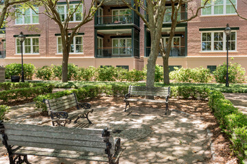 Charleston, South Carolina, USA - July 2, 2025: Circle of wrought iron benches under shady trees in...