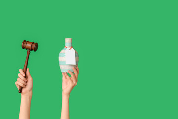 Woman holding auction gavel and antique vase on green background