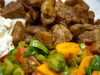A serving of traditional Turkish kavurma or beef saute with a side of fresh vegetable salad creating a complete and delicious meal that is rich in protein and vitamins