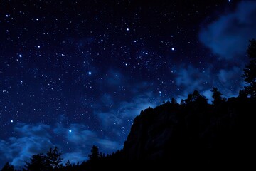 Fototapeta premium Starry night over a dark mountain silhouette