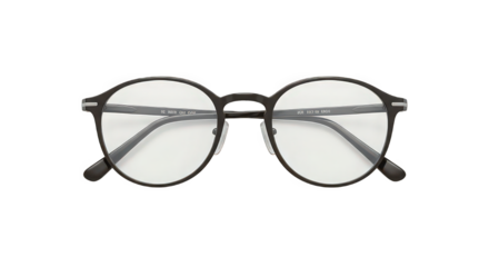 A pair of round eyeglasses with black frames and clear lenses on a black background in a studio shot