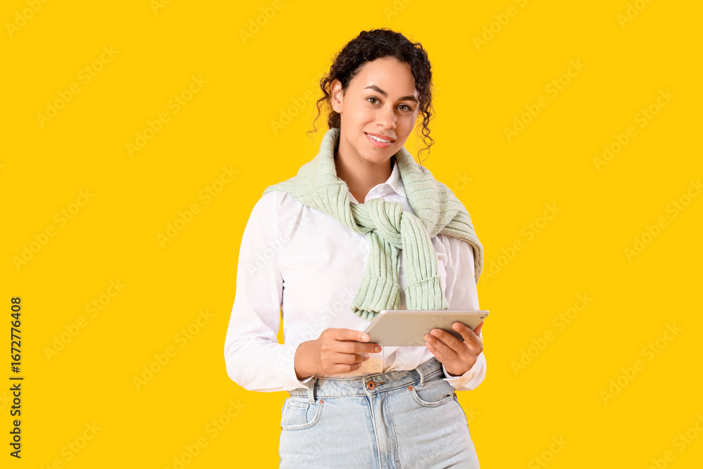 Aufkleber young african-american qa engineer with tablet computer on yellow background