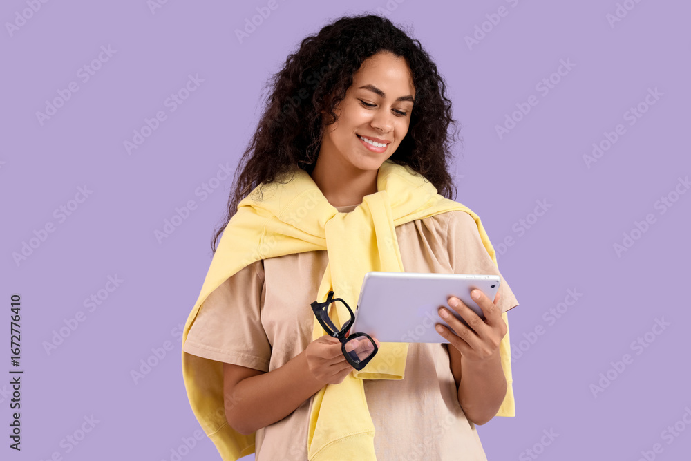 Poster young african-american qa engineer with tablet computer on purple background