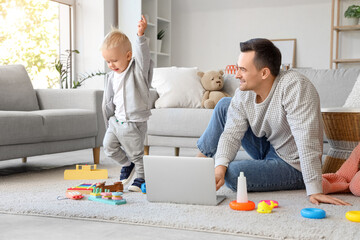 Young father and his little son at home