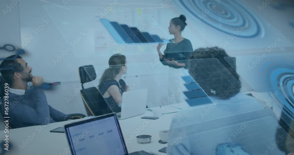 Poster speaker tapping tablet and pointing at chart while colleagues viewing overlay for business planning