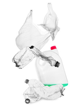 plastic waste: bottles, bags, and containers on black