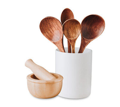 wooden spoons and a mortar with pestle on black