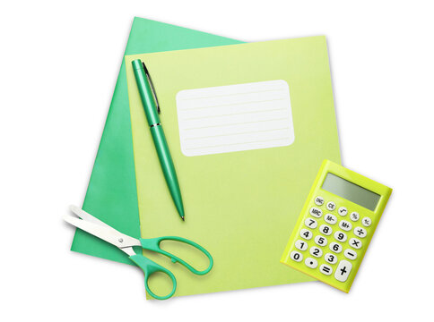 green notebook, pen, scissors, and calculator on black