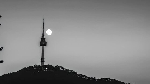 Tranquil time-lapse captures the ethereal moonset behind the iconic N Seoul Tower at dusk