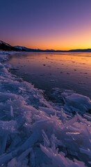 Frozen lake shore at sunset