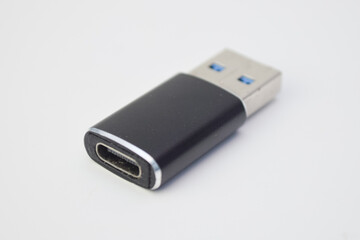 Black USB to USB-C adapter isolated on white background, modern technology connector for data...