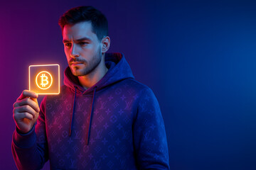 young man holding a bitcoin digital card