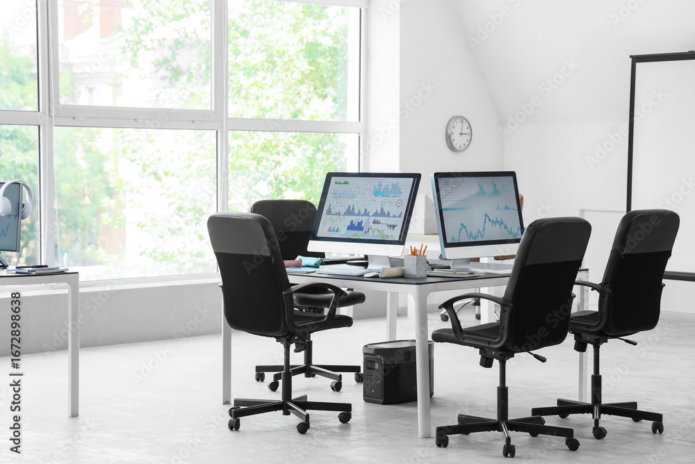 Poster table with computer monitors in school computer lab