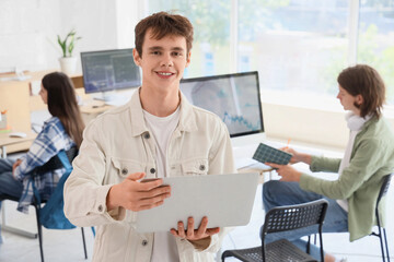 Obraz premium Male student with laptop at school computer lab