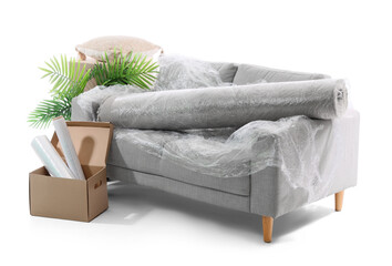 Wrapped sofa and carpet with stretch film on white background