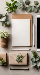 Flatlay of stationery, greenery, and gifts