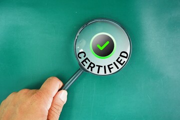 Magnifying glass and the word certified with a check mark and a green background. designated...