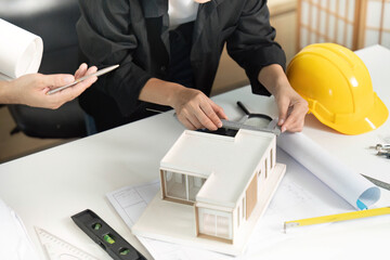 Engineers Measuring Building Model with Tools
