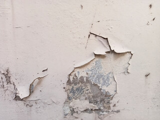 background of peeling wall paint, close up of wall texture with peeling wall paint due to water and...