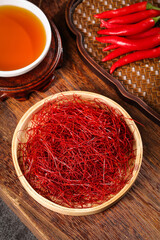 Dried Red Chili Peppers Julienned and Shredded with Fresh Peppers and Tea on Wooden Background