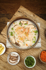 Chinese Seafood Congee with Shrimp and Shiitake Mushrooms in Clay Pot - Traditional Asian Rice Porridge